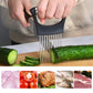 Black onion slicer fork pressed down on vegetables with stainless steel pins