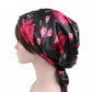 Black satin turban hat with pink floral print and side ribbon bow