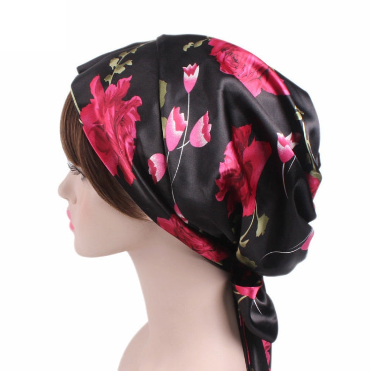 Black satin turban hat with pink floral print and side ribbon bow