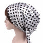 White satin turban hat with black polka dots and side drape tie