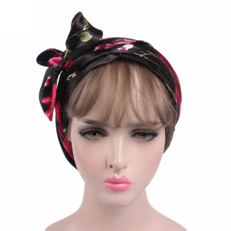 Satin ribbon bow turban hat in black with red and gold leaf print, side bow
