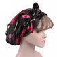 Satin ribbon bow turban hat in black with pink floral print, side view of bow