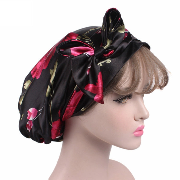Satin ribbon bow turban hat in black with pink floral print, side view of bow