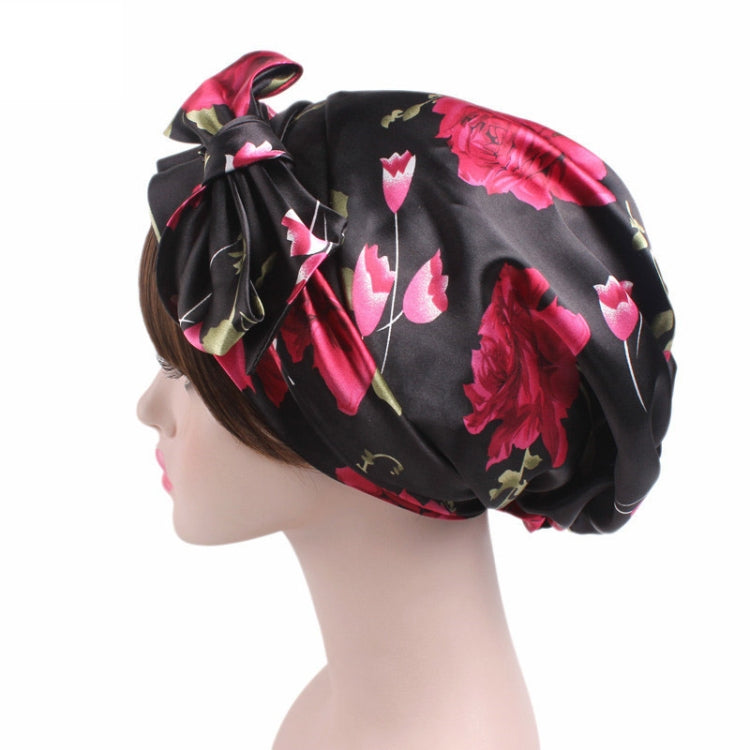 Satin print ribbon bow turban hat in black with pink tulip pattern, side bow