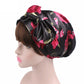 Satin print ribbon bow turban hat in black with pink-red tulip pattern, angled bow