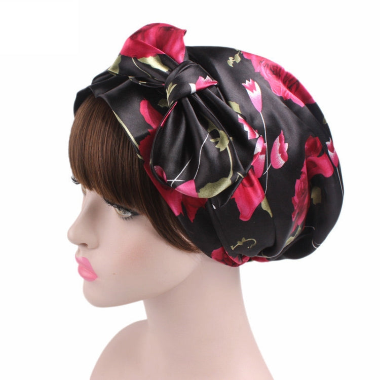 Satin print ribbon bow turban hat in black with pink-red tulip pattern, angled bow