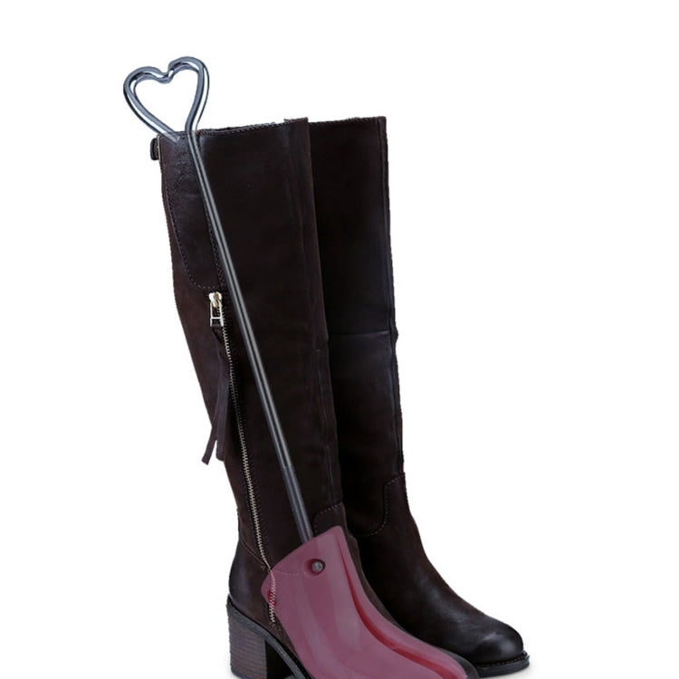 Black tall boots with zipper, fitted with a pink boot shoe expander
