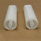 Close-up of two white nozzle holders showing bottom outlet openings