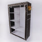 Brown patterned fabric closet with open shelves and hanging rod