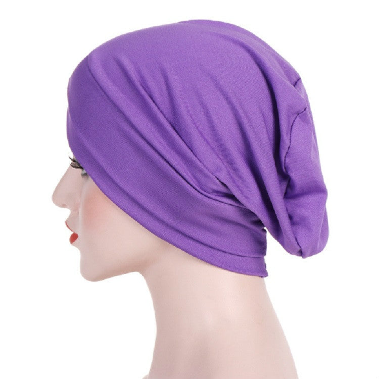 Purple stretch headscarf cap with forehead cross wrap, side view