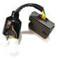 Motorcycle rectifier/regulator with black case, finned heatsink, and colored wiring leads