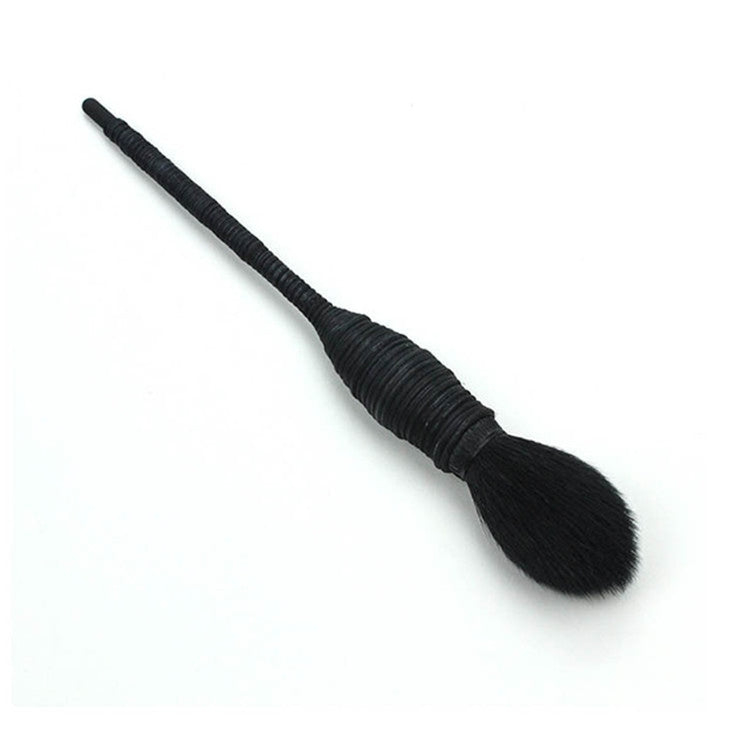 Blush makeup brush angled view with black ribbed handle and rounded bristle head
