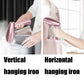 Rose-pink handheld garment steamer steaming fabric vertically and horizontally