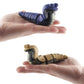 Purple and gray cobra remote-control toys being held in hands for size comparison.