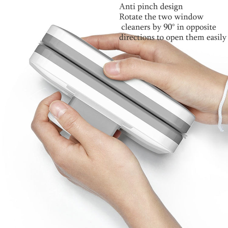 Double-sided magnetic window wiper with two parts rotated for opening, hands holding device