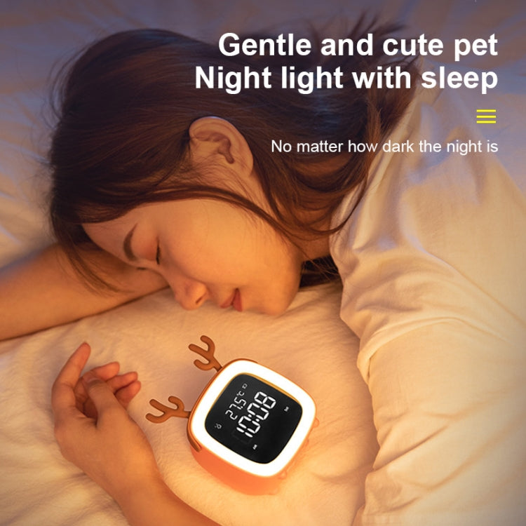 Deer-shaped kids LED alarm clock with glowing digital time display on bedside