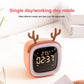 Coral red deer-shaped LED alarm clock on bedside surface with bright time display