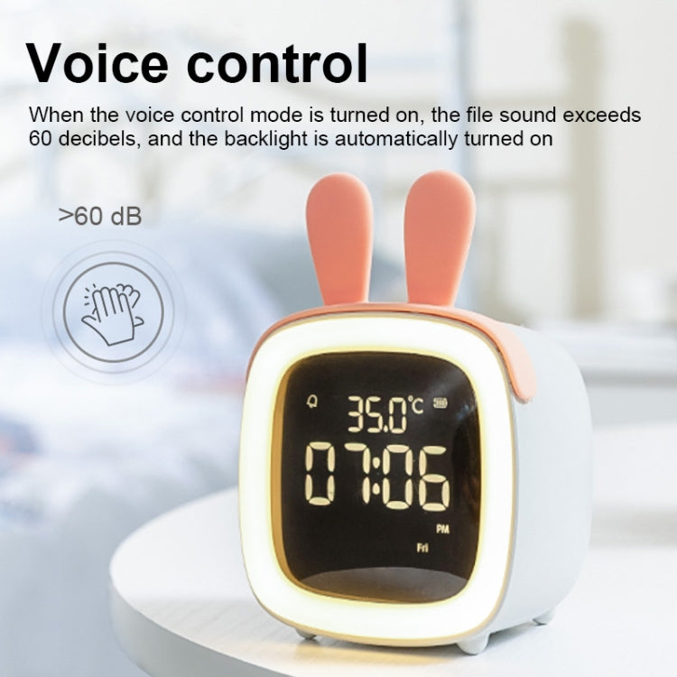 White and coral deer-shaped LED alarm clock with glowing digits on the front screen