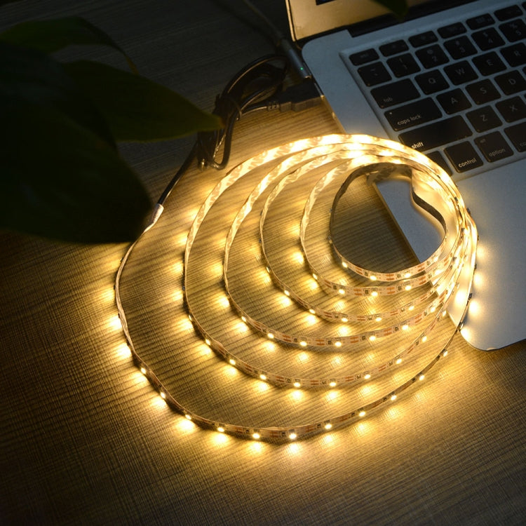 Warm white glowing USB LED strip light coiled on a surface