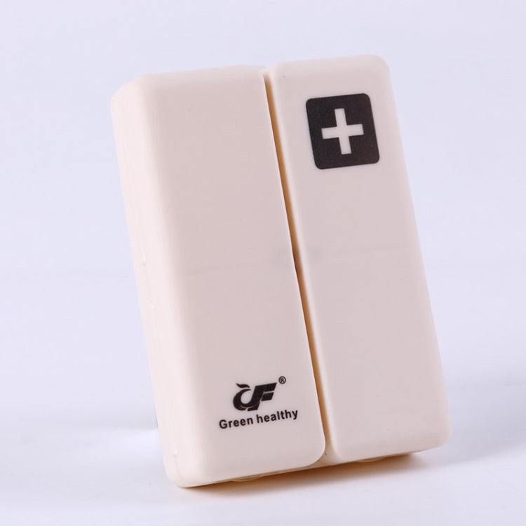 White folding pill box with plus symbol, compact two-panel sealed case