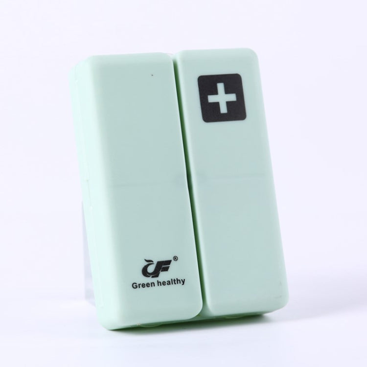 Mint green folding pill box with plus symbol, compact two-panel sealed case