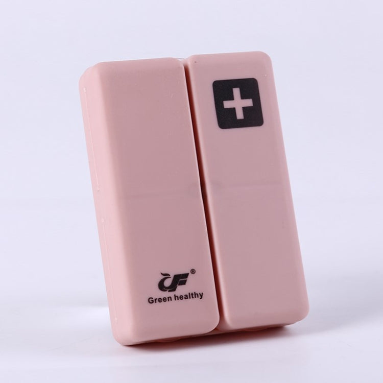Pink folding pill box with plus symbol, compact two-panel sealed case
