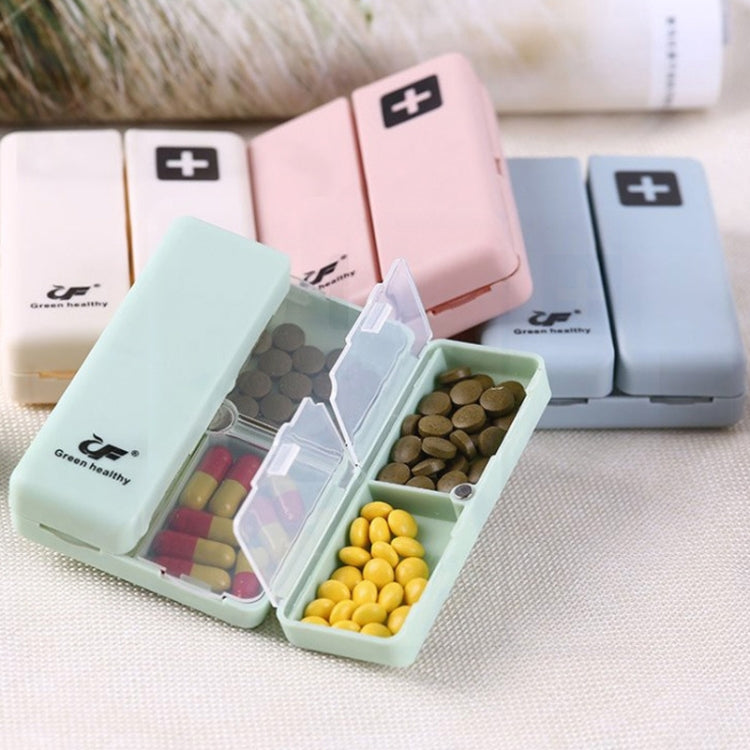 Open pill organizer case with divided compartments and clear panels holding tablets