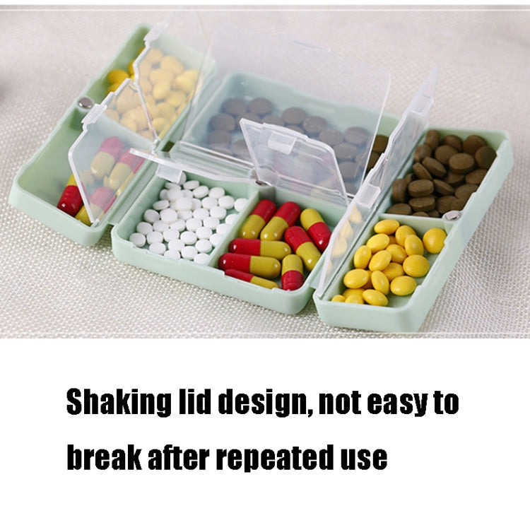 Open pill box with divided trays and clear shaker lids, tablets in compartments