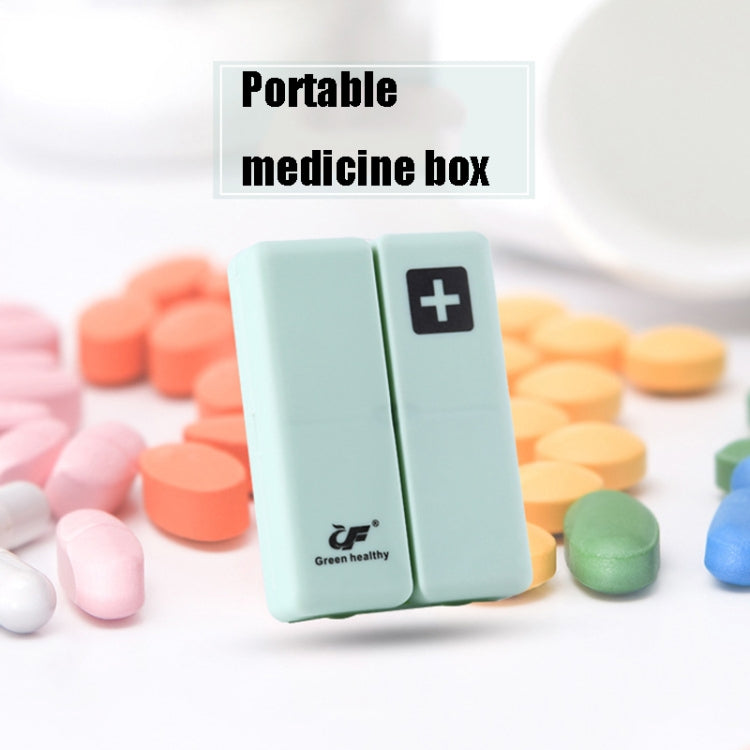 Light green folding pill box with plus symbol, shown with assorted tablets