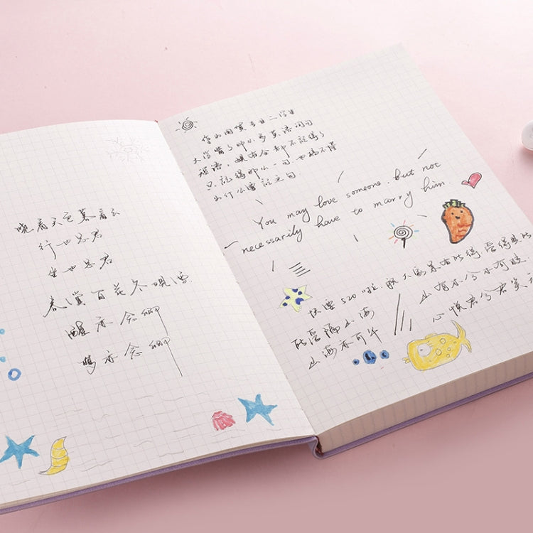 A5 notebook open with writing on graph paper and cute doodle decorations