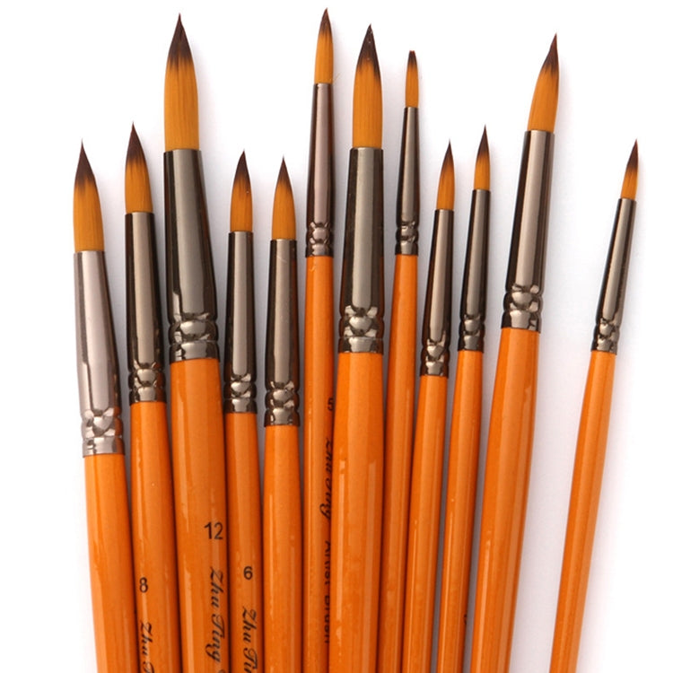 Close-up of watercolor hook-and-line brushes with orange handles and tapered bristle tips