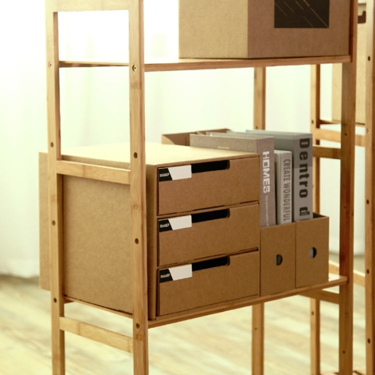 Cardboard storage cabinet on wooden frame with three drawer fronts and round pull holes