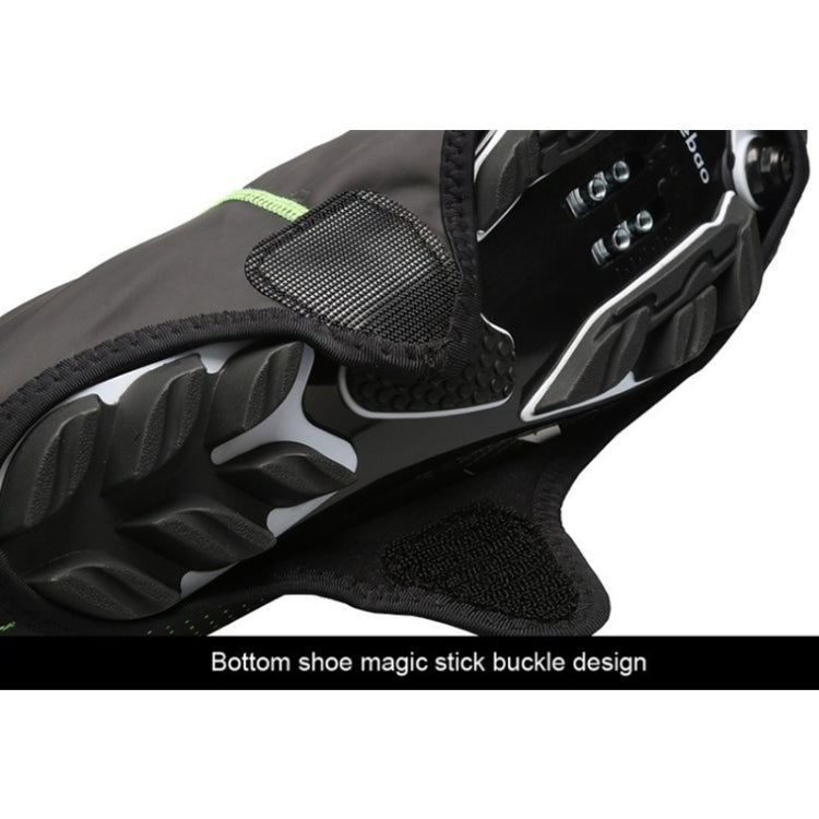 Bottom view of black cycling shoe cover with textured grip and strap for closure