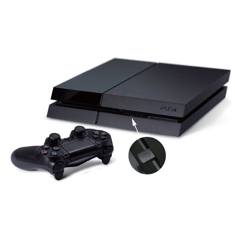 Bluetooth receiver adapter placed beside PS5 console and controller