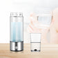 Stainless steel water cup with clear body, blue-tinted water, and base control button