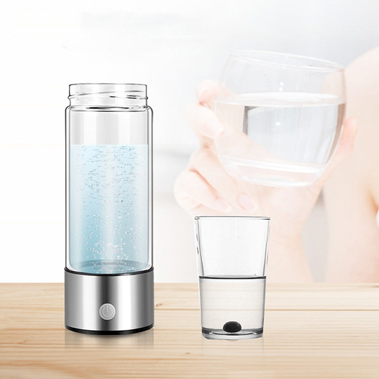 Stainless steel water cup with clear body, blue-tinted water, and base control button