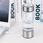 Portable water cup with clear chamber and stainless steel base; charging cable connected