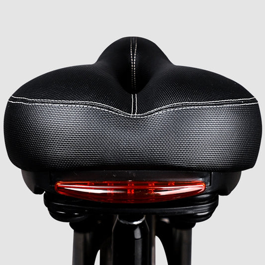 Black bicycle saddle with rear red taillight and stitched center seam