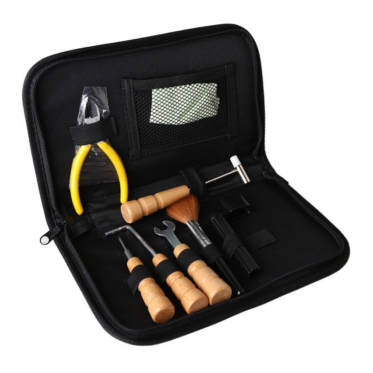 Guitar string changing kit in black zip case with yellow cutters and tools