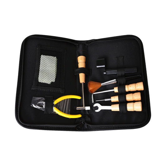 Guitar string changing kit tools arranged inside black zip pouch, with yellow pliers