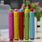 Colored dustless chalk sticks with printed text on barrels, from pink to blue