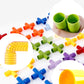 Plastic pipe building blocks with green tubes held in hand and scattered colorful parts