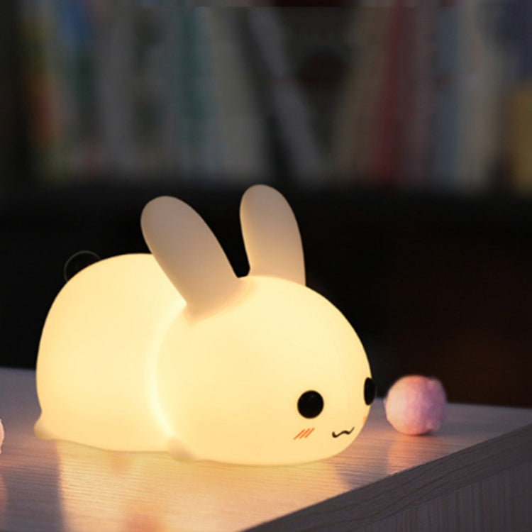 Yellow rabbit-shaped LED night light with small face and raised ears