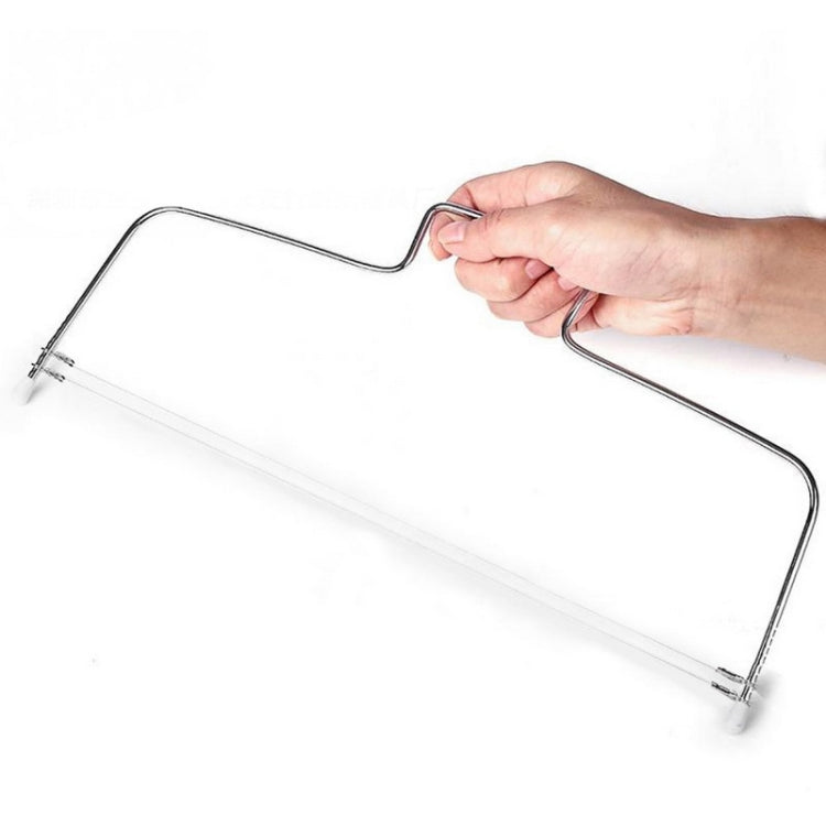Stainless steel wire cake cutter held in hand; long cutting wire with pegs