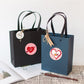 Valentine heart sticker labels on black and blue gift bags, round heart icons