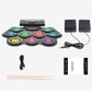Electronic drum starter set with colored pads, drumsticks, cables, and two speakers