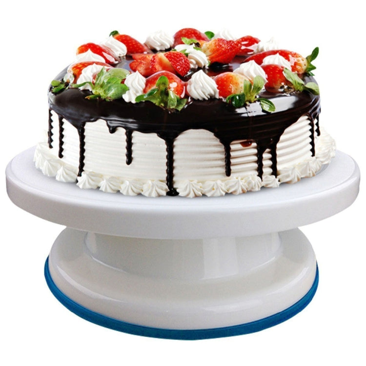 Plastic cake turntable supporting a chocolate-topped cake with cream border