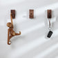 Wood wall hooks with rounded pegs holding keys and small accessories