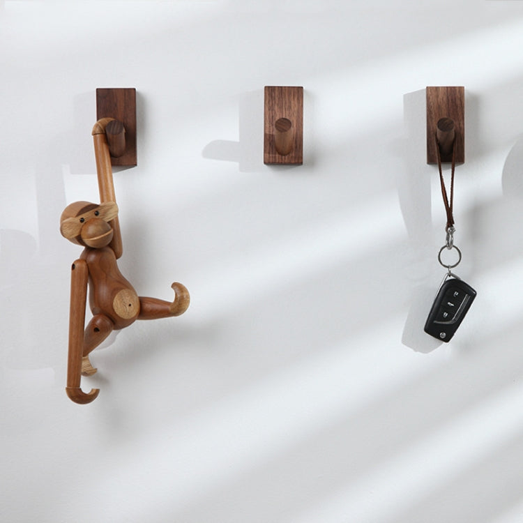Wood wall hooks with rounded pegs holding keys and small accessories