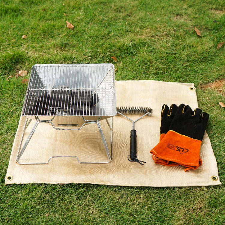 Beige heat insulation pad cloth with corner grommets laid out for barbecue.